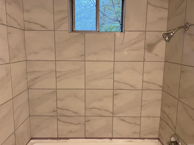 bathroom with a tile shower