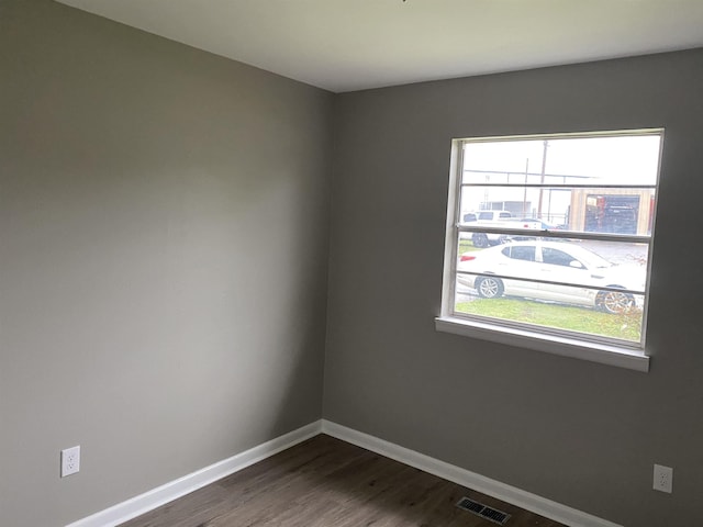 empty room featuring dark hardwood / wood-style flooring