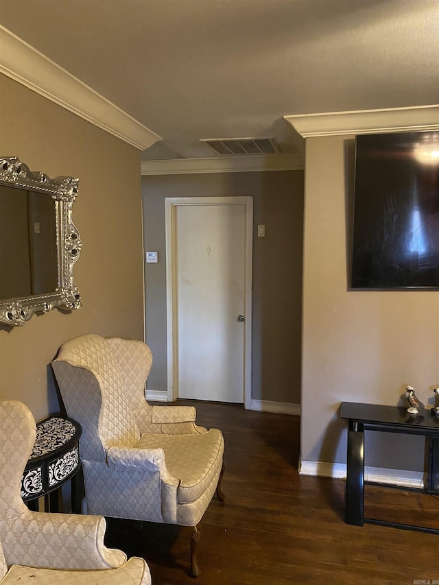 living area with crown molding and dark hardwood / wood-style floors