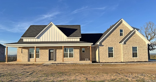 view of front of property with brick siding and board and batten siding