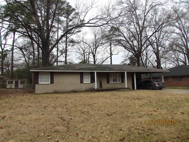 ranch-style house featuring a carport and a front lawn