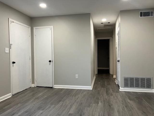 unfurnished room with dark wood-type flooring