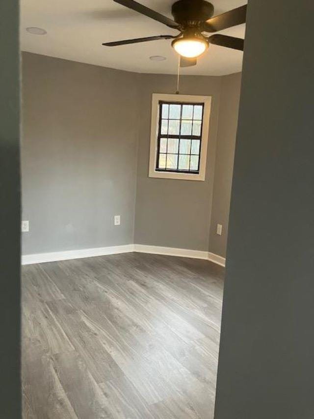 spare room featuring ceiling fan and hardwood / wood-style floors