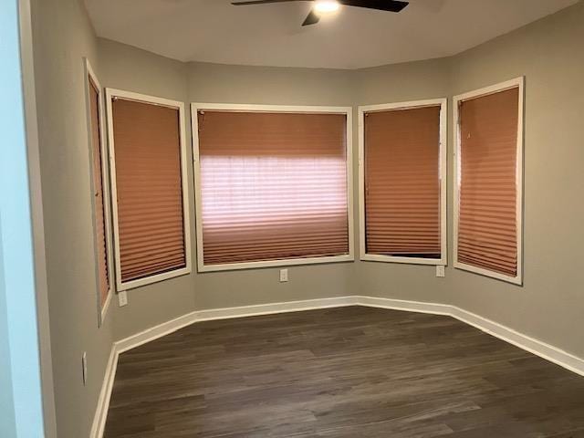 spare room with ceiling fan and dark hardwood / wood-style flooring