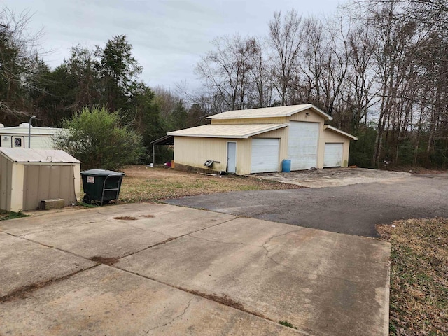 view of property exterior featuring a garage and an outdoor structure