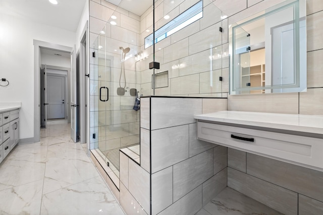 bathroom with walk in shower and vanity