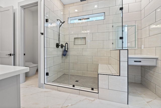 bathroom featuring toilet and an enclosed shower