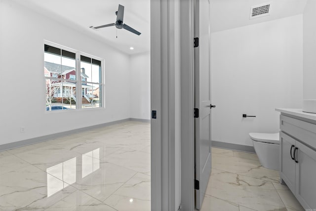 bathroom featuring vanity, ceiling fan, and toilet