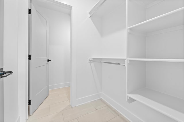 walk in closet featuring light tile patterned flooring