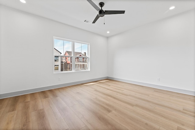 unfurnished room with ceiling fan and light wood-type flooring