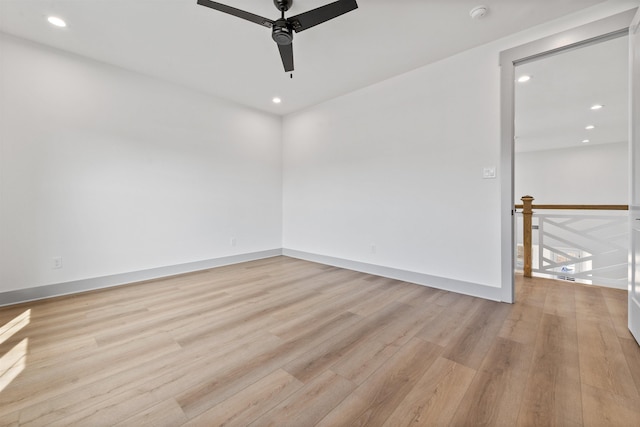 spare room featuring ceiling fan and light wood-type flooring