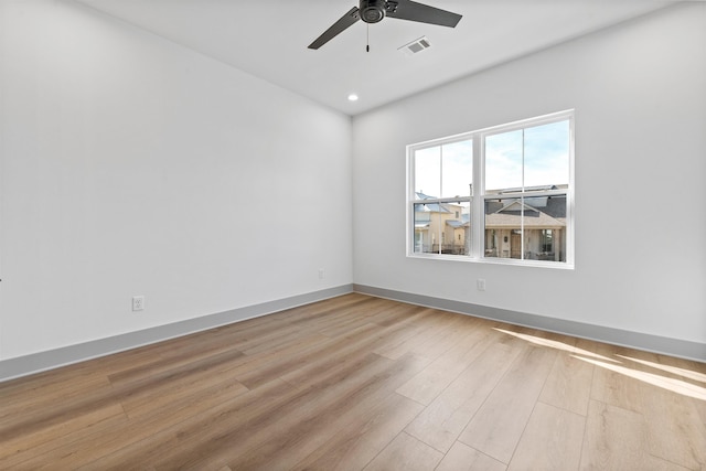 spare room featuring light hardwood / wood-style floors and ceiling fan