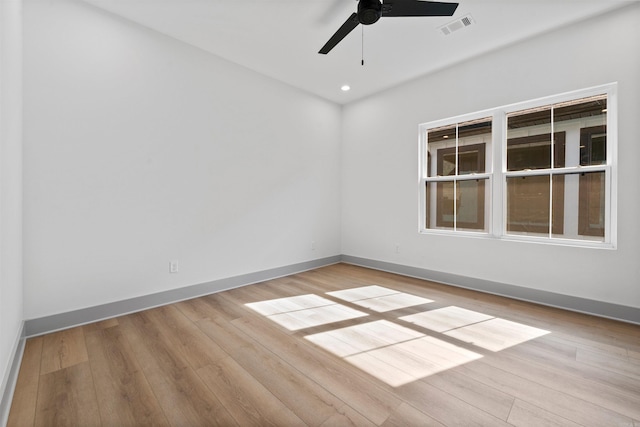 spare room with light hardwood / wood-style floors and ceiling fan