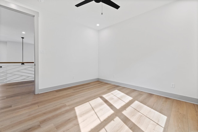 unfurnished room featuring ceiling fan and light hardwood / wood-style flooring