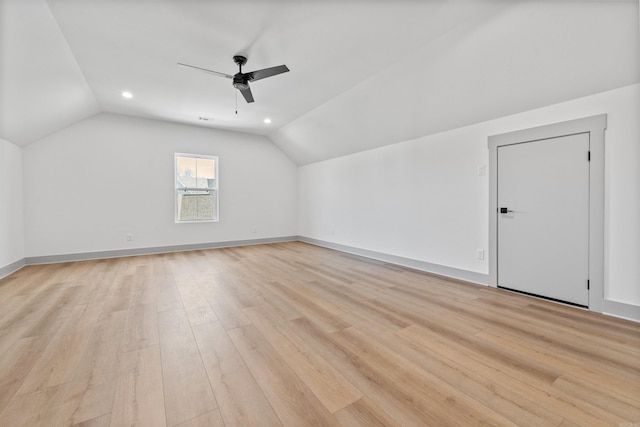 additional living space with vaulted ceiling, ceiling fan, and light wood-type flooring