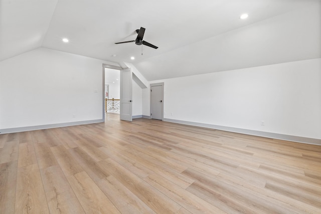 additional living space with vaulted ceiling, ceiling fan, and light hardwood / wood-style flooring