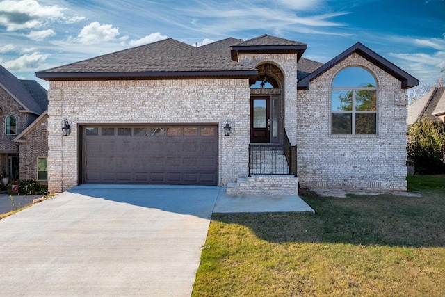 view of front of property with a garage and a front yard