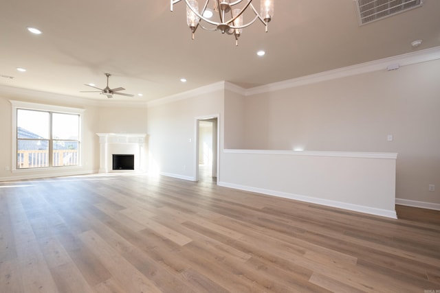 unfurnished living room featuring crown molding, ceiling fan with notable chandelier, and light hardwood / wood-style floors