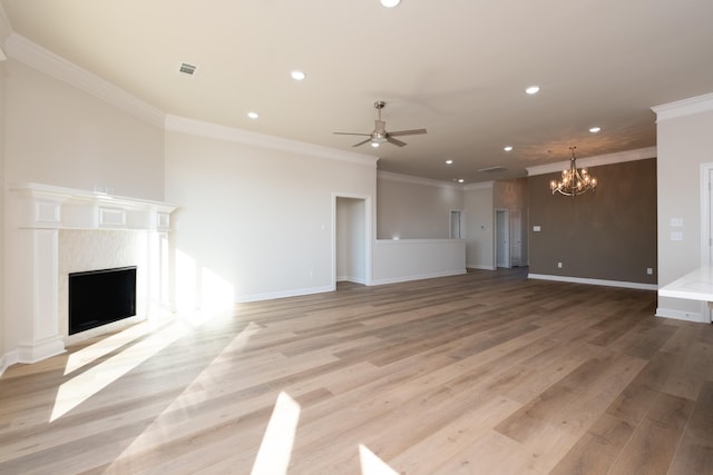 unfurnished living room with crown molding, ceiling fan with notable chandelier, and light hardwood / wood-style floors