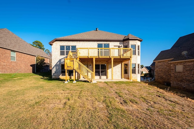 back of house featuring a lawn and a deck