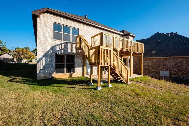 back of property featuring a wooden deck and a yard