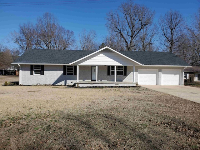 ranch-style home featuring a garage, covered porch, and a front lawn