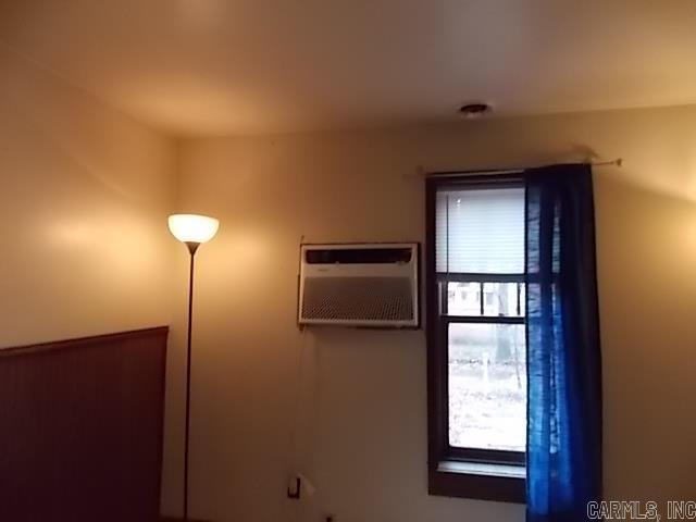 interior space with a wall mounted air conditioner