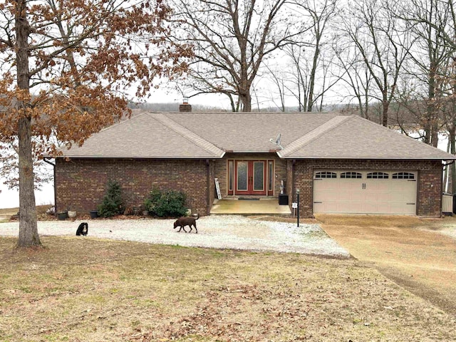 706 S Shore Dr, Horseshoe Bend, AR 72512 - ranch-style home with a garage, a front yard, and french doors