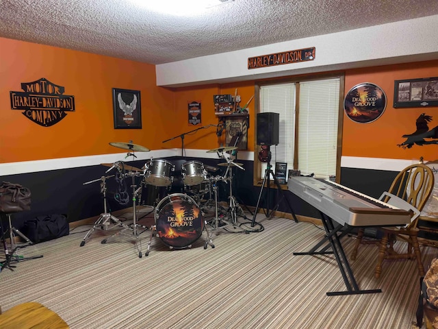 rec room with carpet floors and a textured ceiling