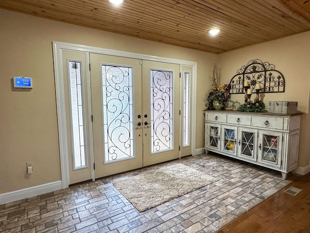 foyer featuring french doors and wooden ceiling