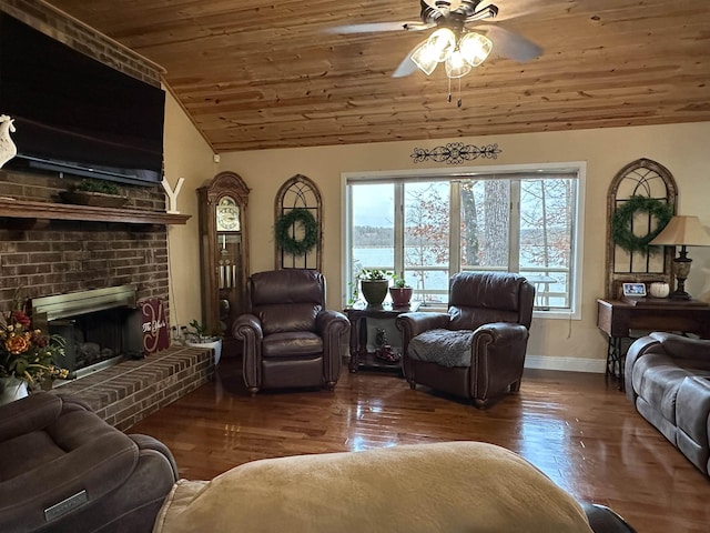 living room with ceiling fan, dark hardwood / wood-style flooring, a brick fireplace, vaulted ceiling, and wooden ceiling