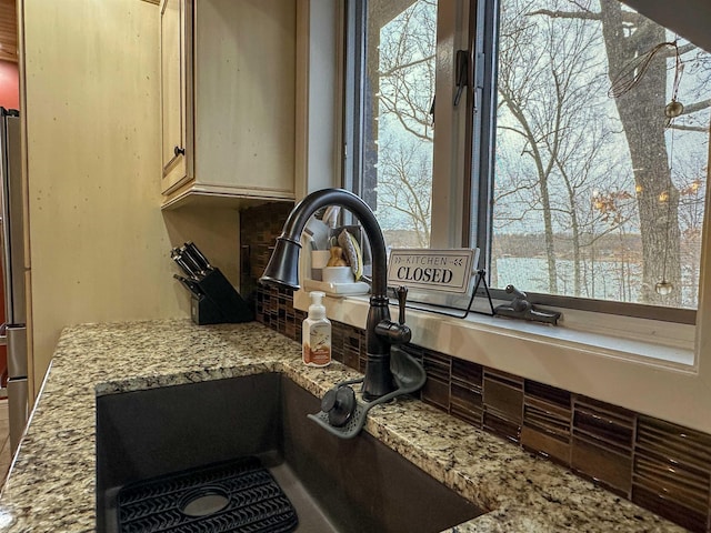 details featuring light stone counters and sink