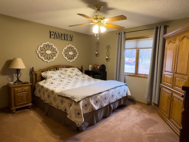 carpeted bedroom with ceiling fan and a textured ceiling