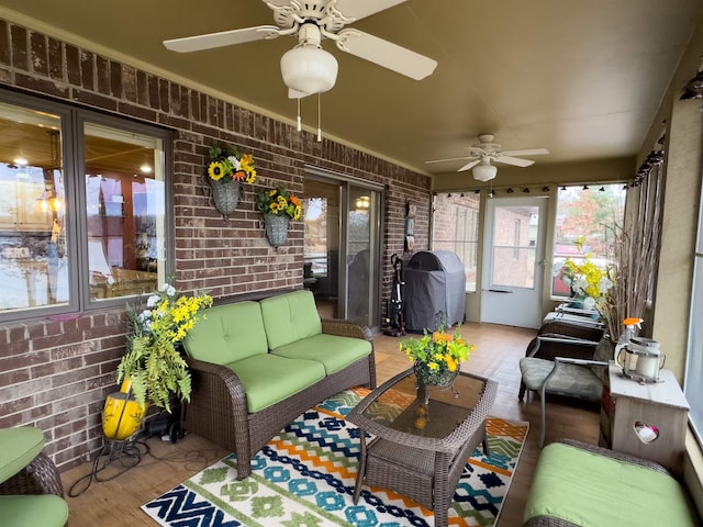 sunroom featuring ceiling fan