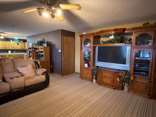 living room with light carpet, a textured ceiling, and ceiling fan