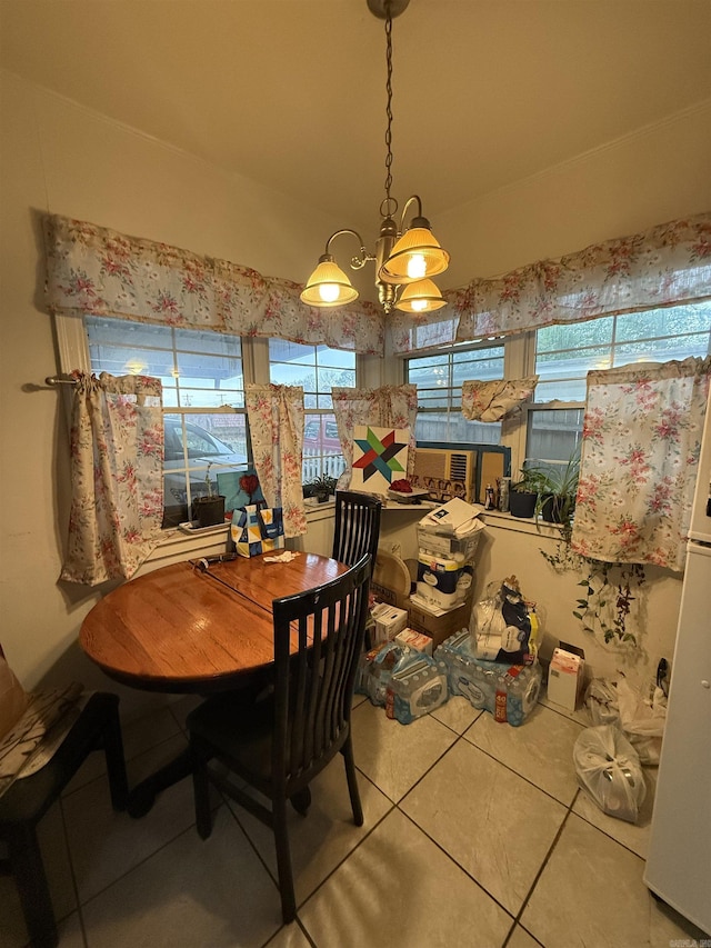 dining room featuring tile patterned flooring and an inviting chandelier