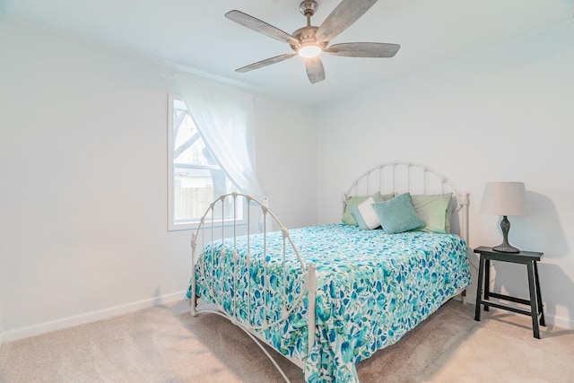 bedroom featuring light colored carpet and ceiling fan