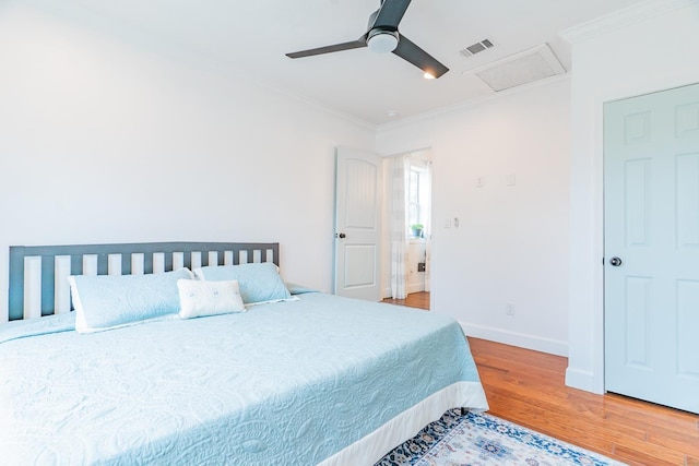 bedroom featuring crown molding, wood-type flooring, and ceiling fan