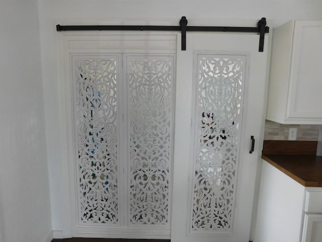 details with tasteful backsplash and a barn door