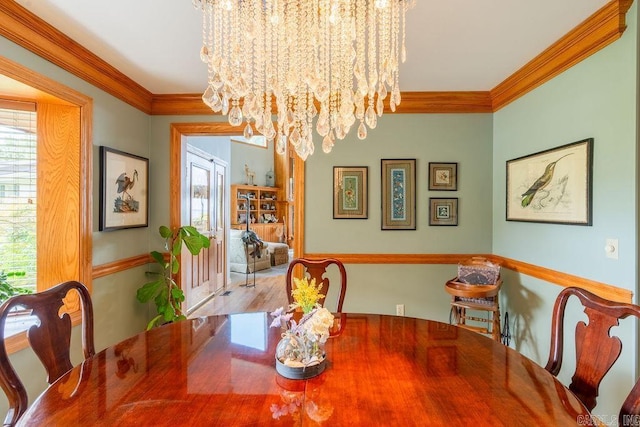 dining space featuring crown molding and a notable chandelier