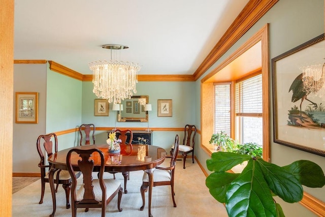 dining area featuring ornamental molding, light carpet, and a notable chandelier