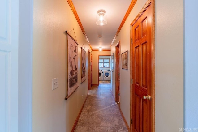 corridor with ornamental molding and washing machine and clothes dryer