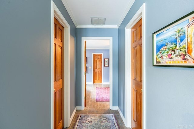 corridor featuring crown molding and dark tile patterned flooring