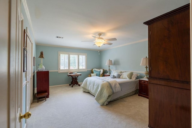 carpeted bedroom with ornamental molding and ceiling fan