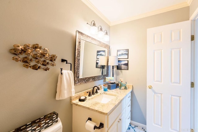 bathroom with ornamental molding, vanity, and toilet