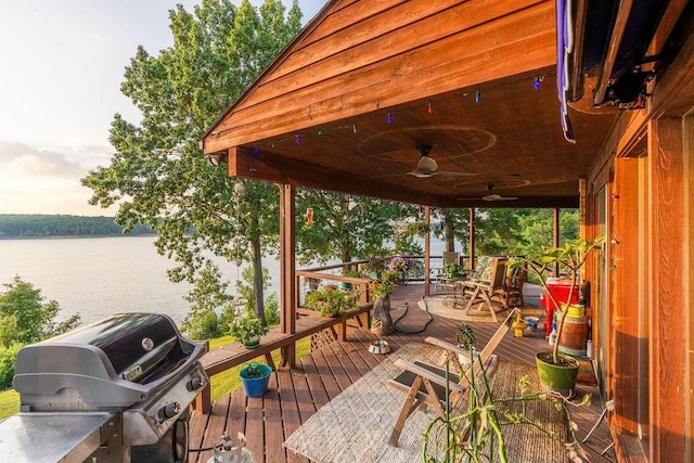 deck featuring a water view, ceiling fan, and a grill