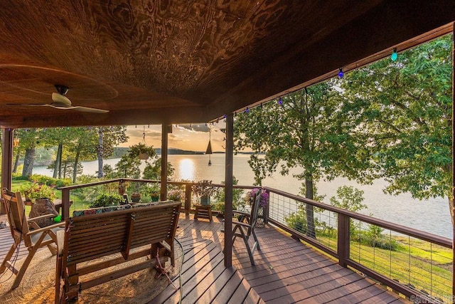 deck featuring a water view and ceiling fan