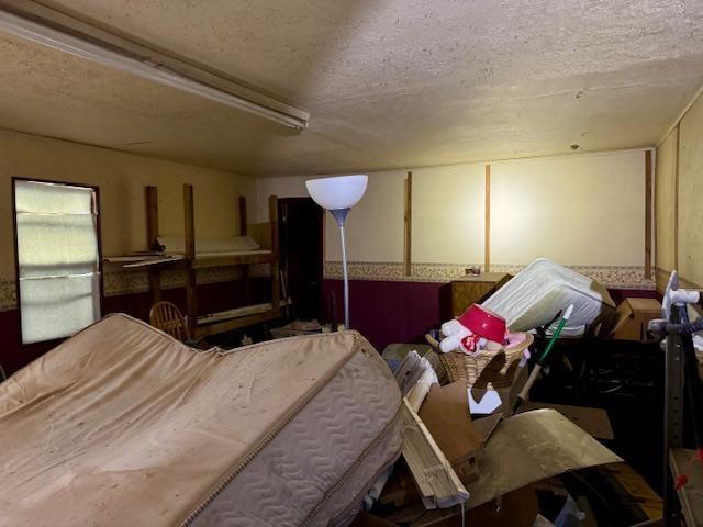 miscellaneous room with a textured ceiling