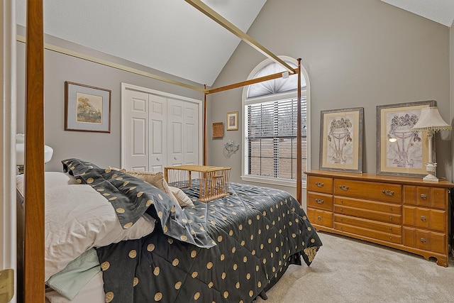 bedroom featuring light carpet, vaulted ceiling, and a closet