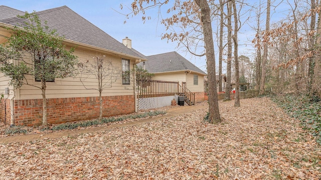 view of home's exterior with a wooden deck